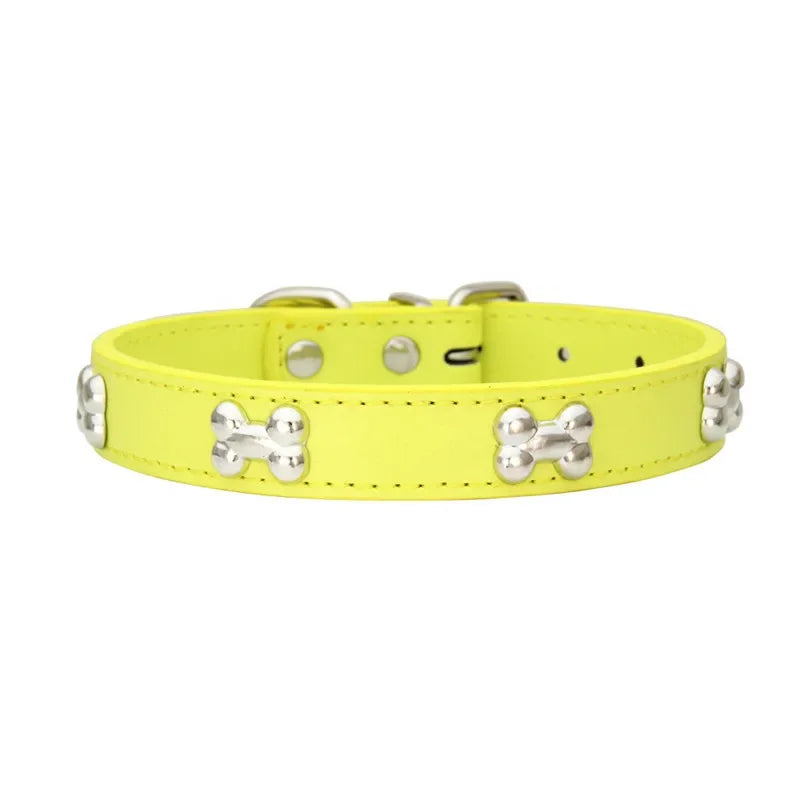 Neon yellow dog collar with silver bone-shaped studs on a white background