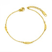 Gold anklet with feather designs on a white background