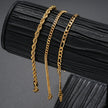 3gold chains on a black textured surface