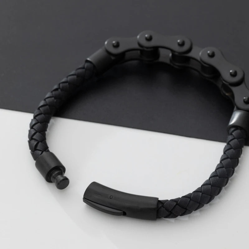 Black braided bracelet with metal clasp on a white surface