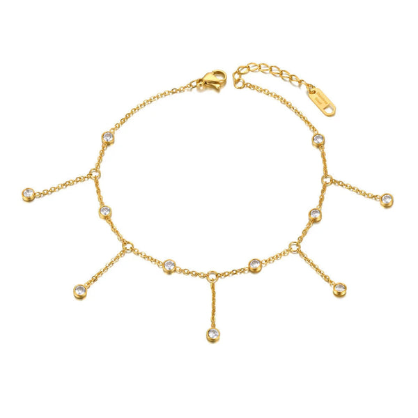 Gold anklet with small beads on a white background