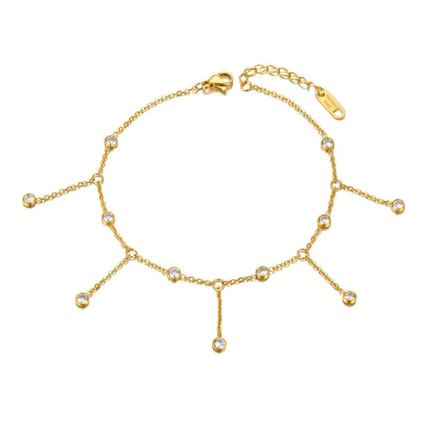 Gold anklet with small beads on a white background