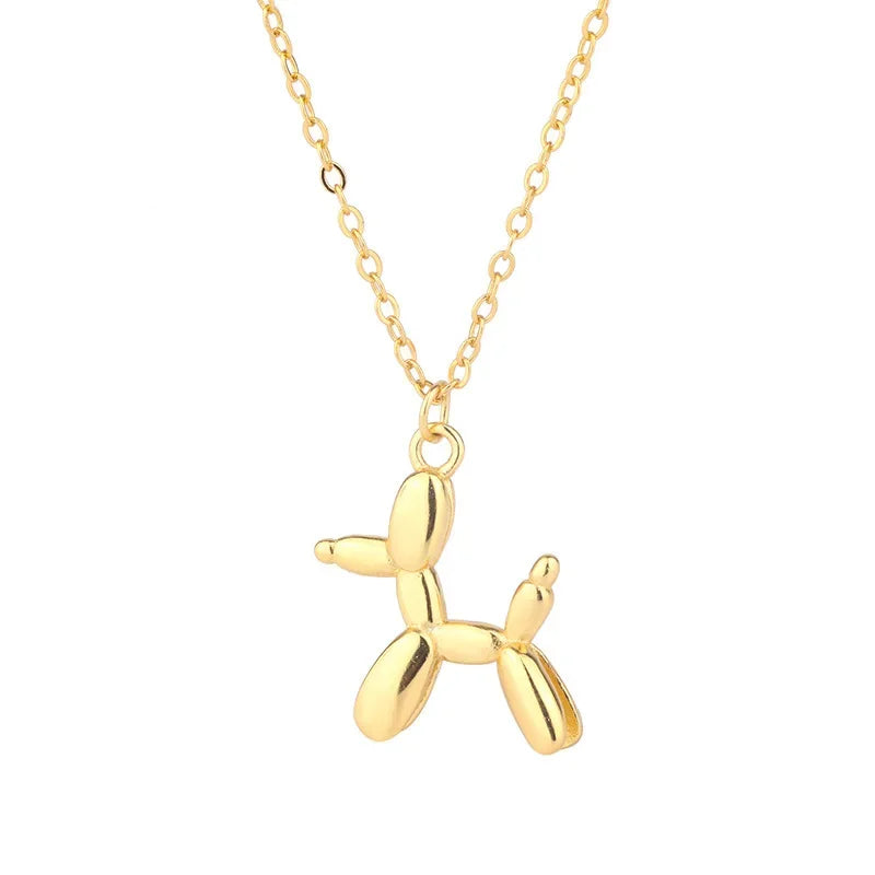 Gold balloon dog pendant necklace on a white background