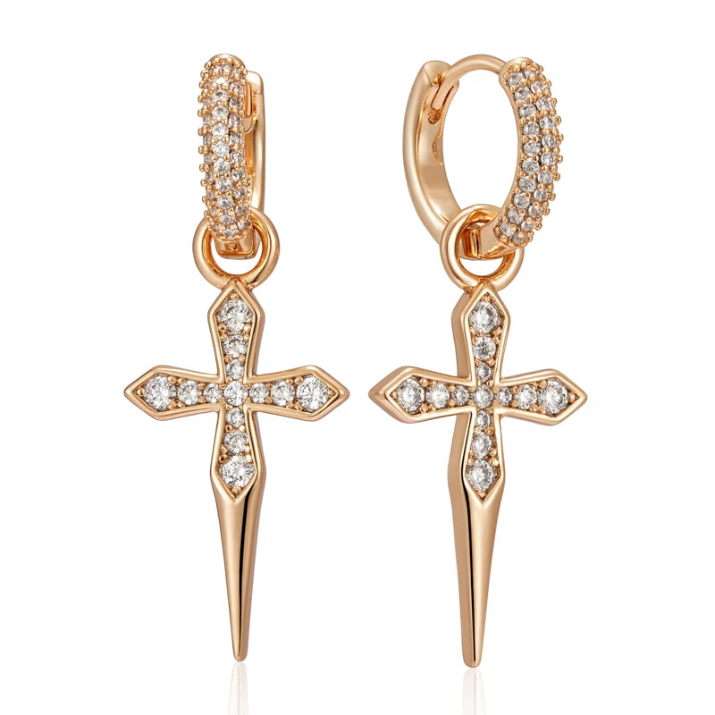 Rose gold cross earrings with clear gemstones on a white background