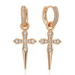 Rose gold cross earrings with clear gemstones on a white background