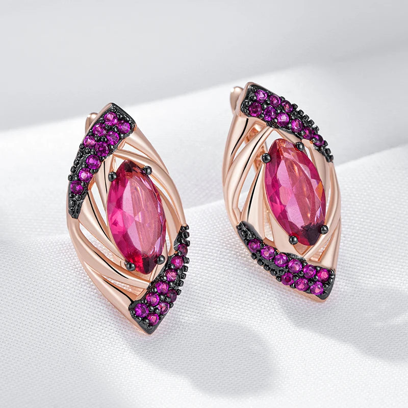 Rose gold earrings with pink gemstones and purple accents on a white background