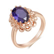 Rose gold ring with a purple gemstone on a white background