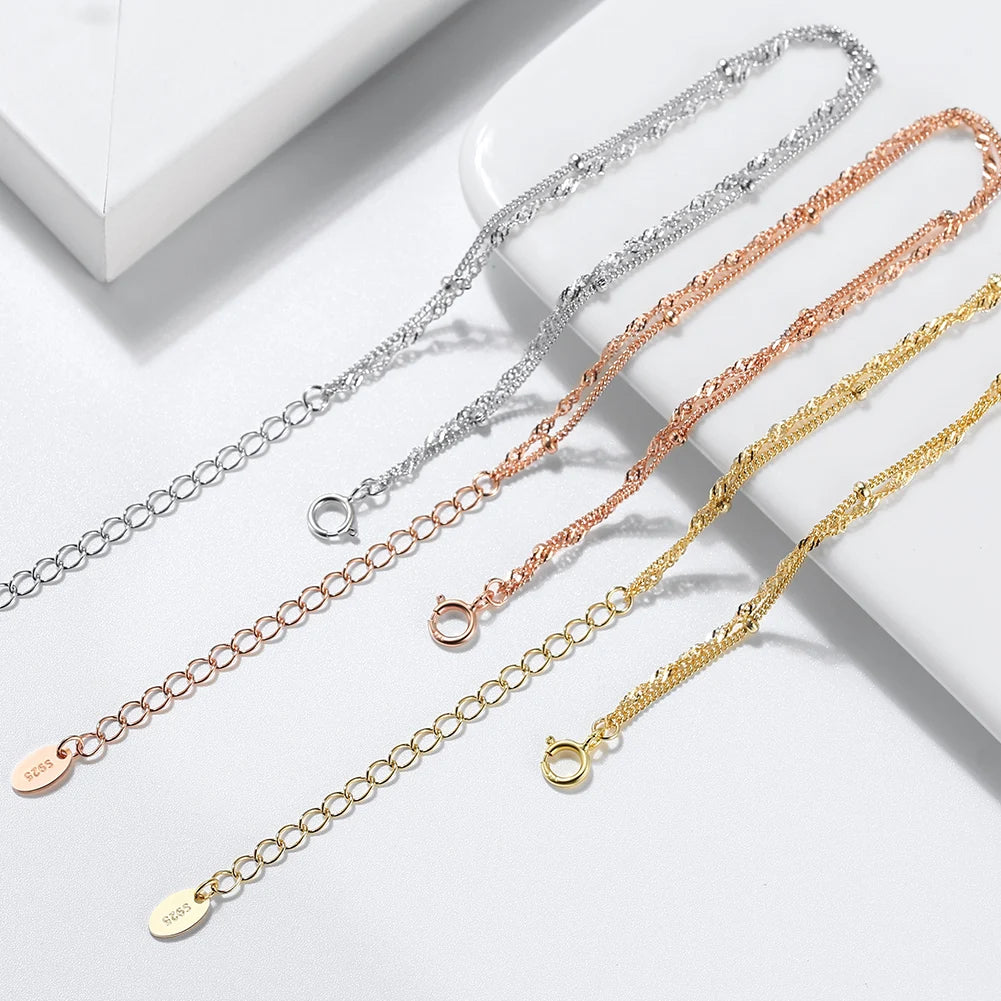 3 bracelets of 3 different colors on a white surface