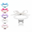 Set of colorful collars with bow and pearl designs on a white background