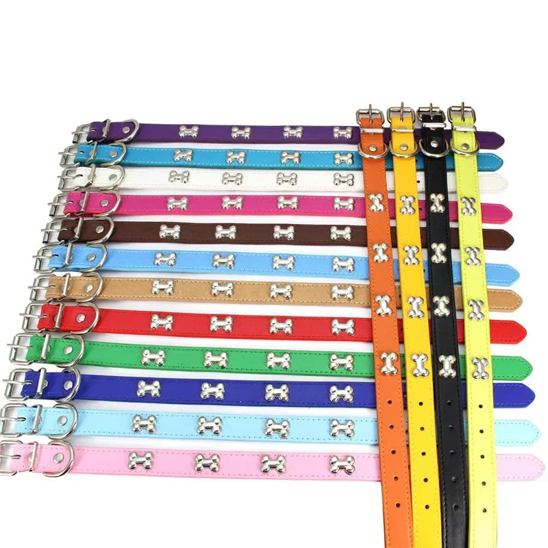 Set of colorful dog collars with bone-shaped metal buckles on a white background