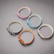 Set of five colorful dog collars on a light gray background