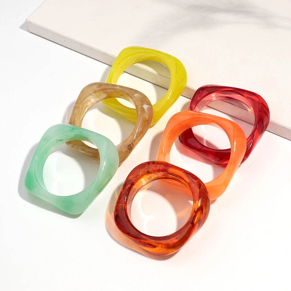 Set of colorful resin bangle on a white surface