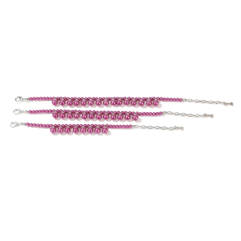 Set of three pink beaded collars on a white background