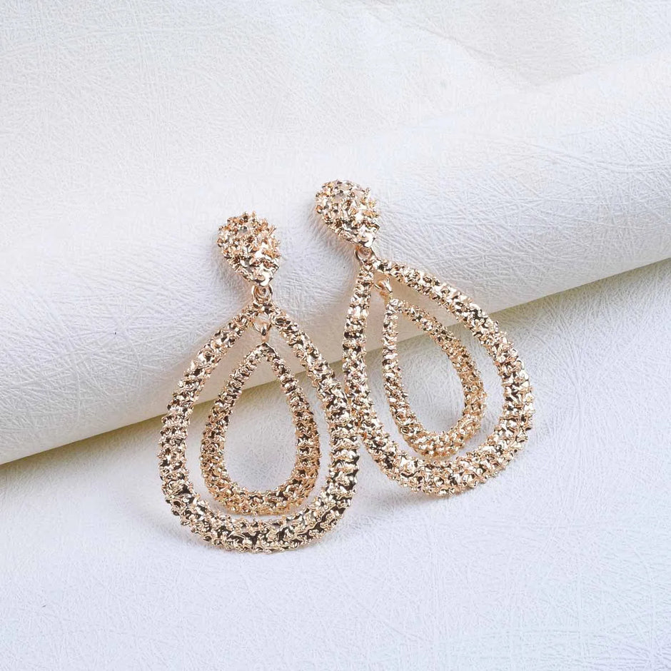 Pair of Gold-plated, double teardrop dangle earrings with a textured, rhinestone-encrusted finish. 