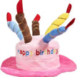Toy birthday cake with colorful candles on a white background