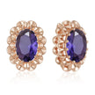 Rose gold earrings with purple gemstones on a white background