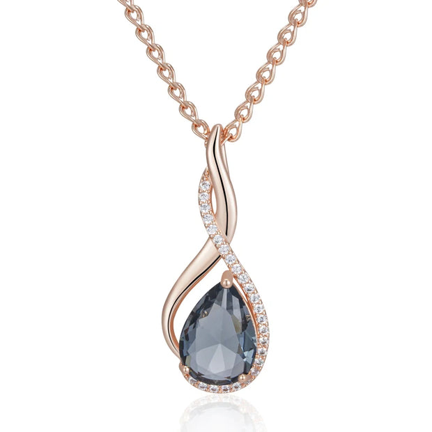 Rose gold necklace with a teardrop-shaped gemstone on a white background