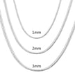Three silver chain necklaces of different thicknesses on a white background