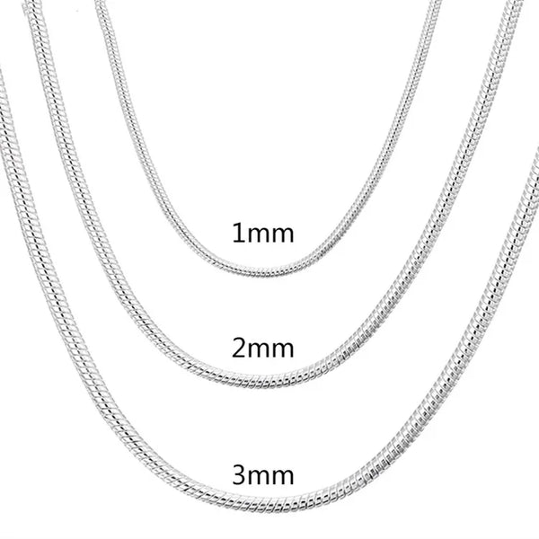 Three silver chain necklaces of different thicknesses on a white background