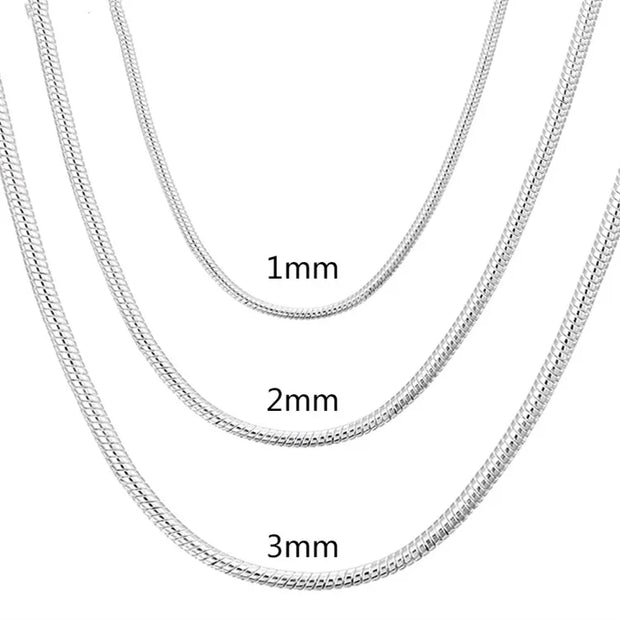 Three silver chain necklaces of different thicknesses on a white background