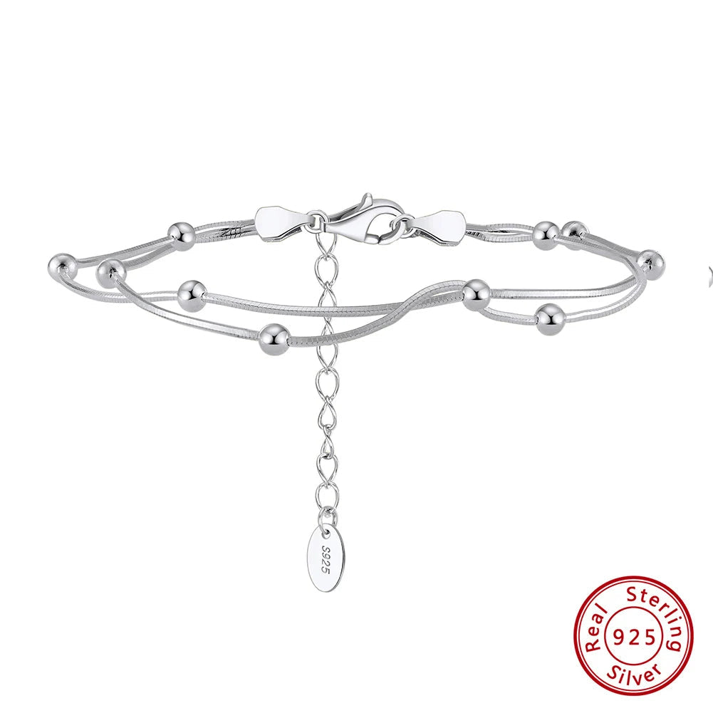 Silver bracelet with a chain detail on a white background, featuring Orsa Jewels branding.