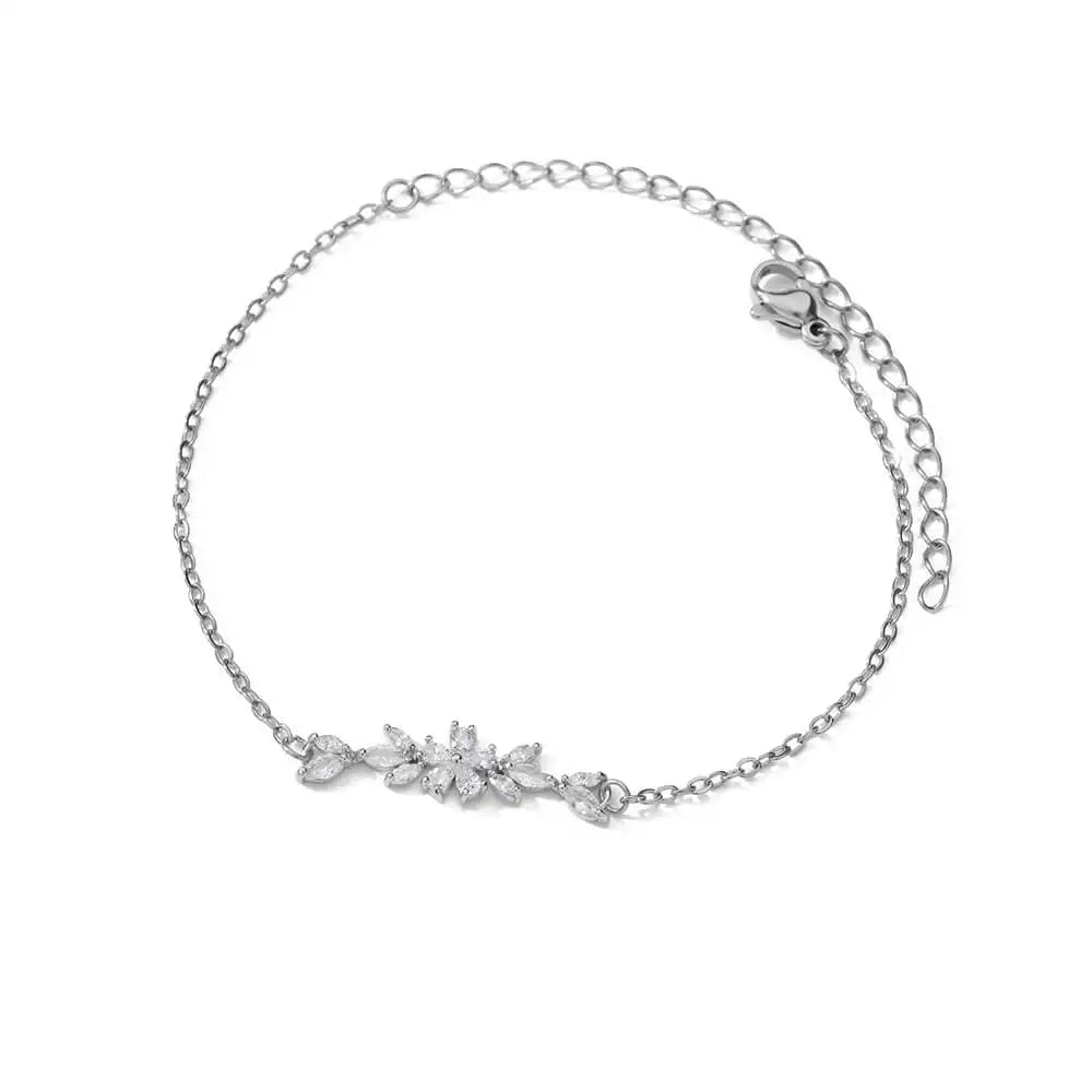 Silver bracelet with a floral design on a white background
