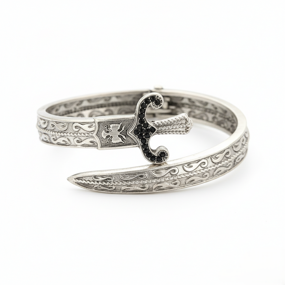 Silver bracelet with intricate design on a white background