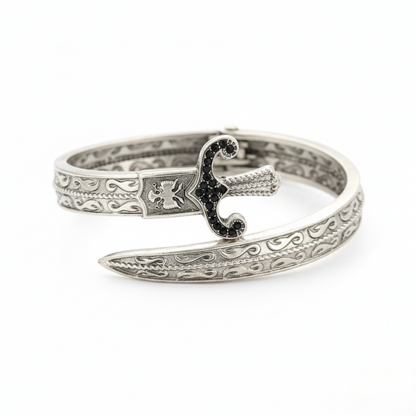 Silver bracelet with intricate design on a white background