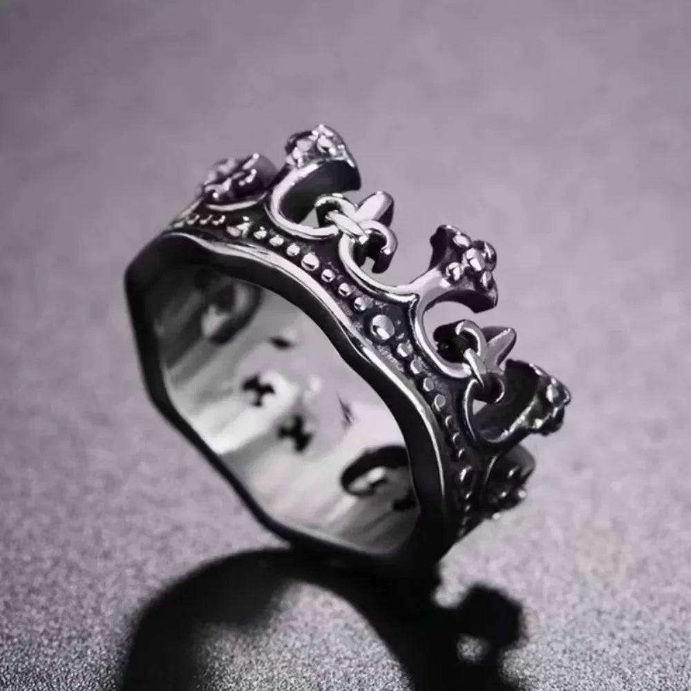 Silver crown-shaped ring on a textured gray background