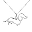 Silver dachshund-shaped pendant on a chain against a white background