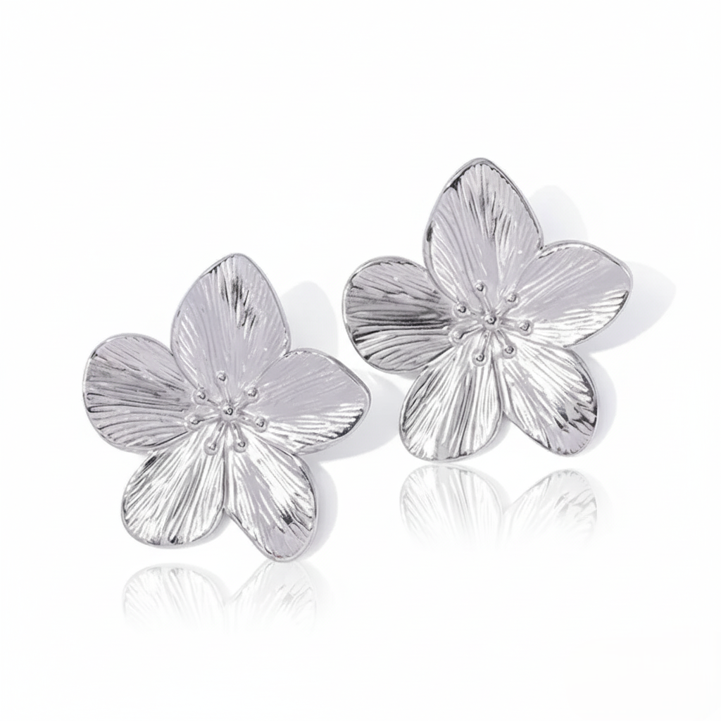 Silver flower-shaped earrings on a white background