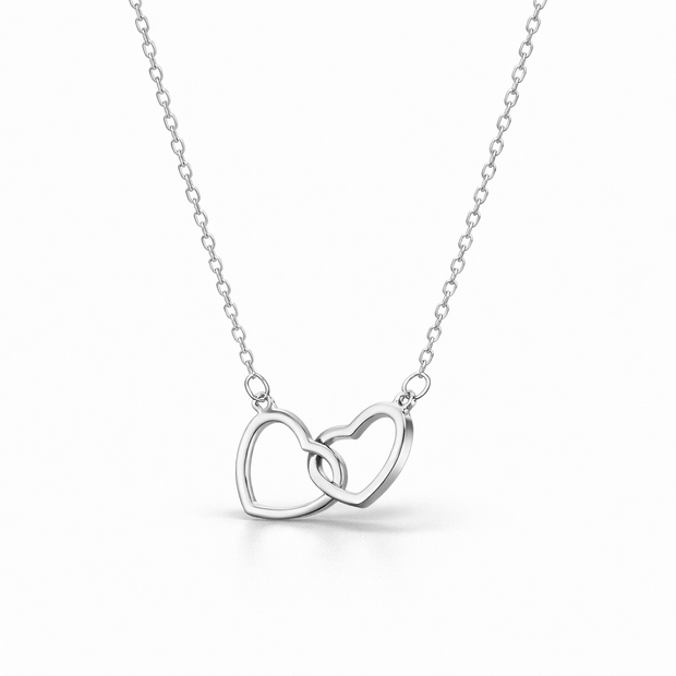 Silver hearts necklace with interlocking heart pendants on a white background