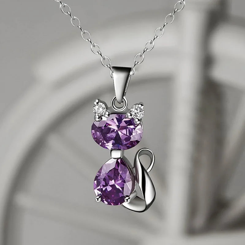 Silver necklace with purple gemstone pendant on a neutral background