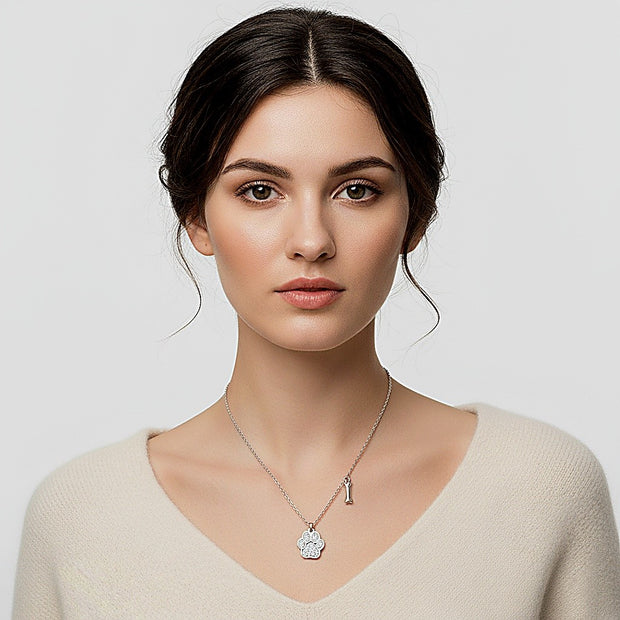 Woman wearing a necklace with a pendant against a plain background