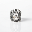 Silver ring with angel design on a white background