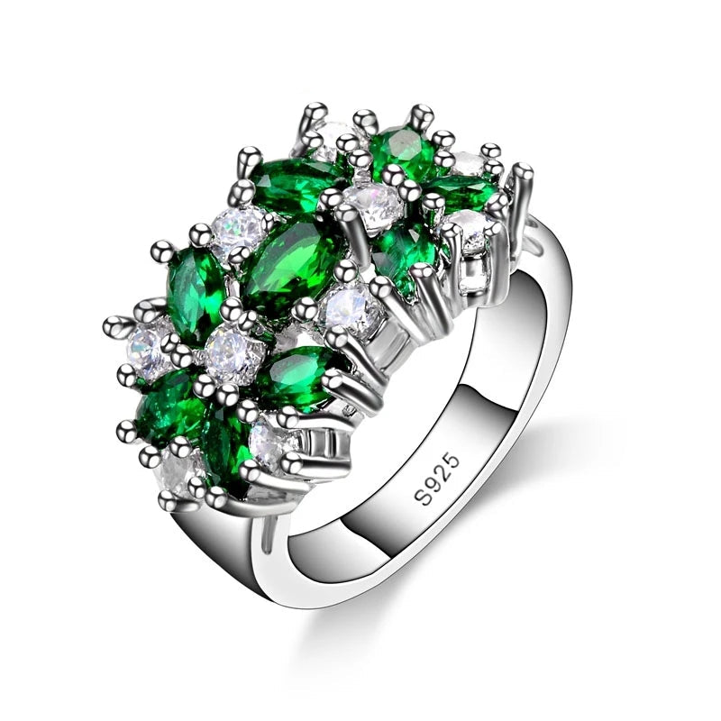 Silver ring with green and clear gemstones on a white background, branded 'Factory-Outlets'.