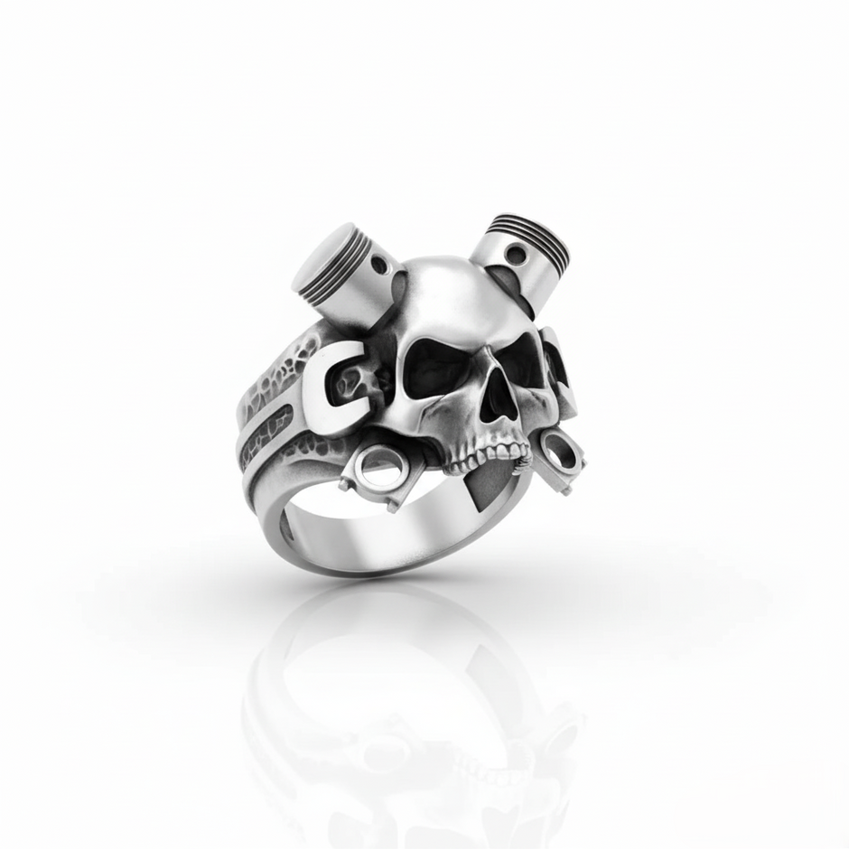 Silver ring with skull and piston design on a white background