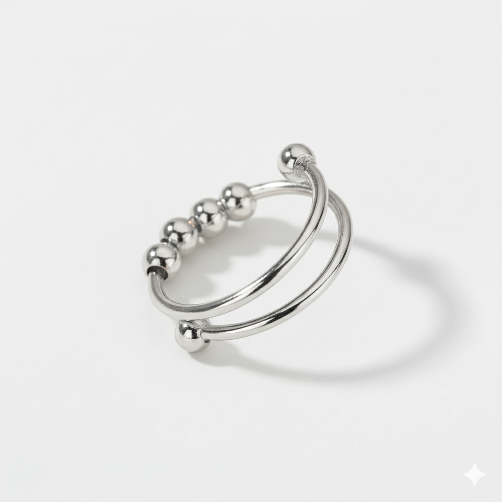 Silver ring with spherical elements on a light gray background