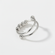 Silver ring with spherical elements on a light gray background