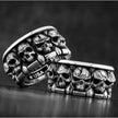 Silver ring with skull design on a dark background