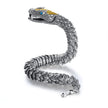 Silver snake-shaped bracelet with detailed design on a white background