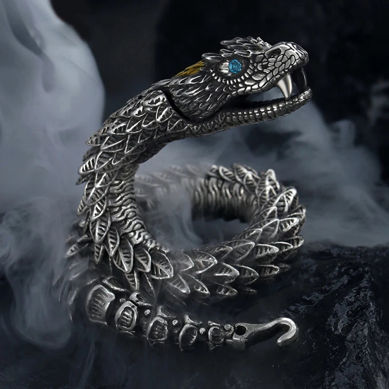Silver snake-shaped bracelet with detailed design on a dark background