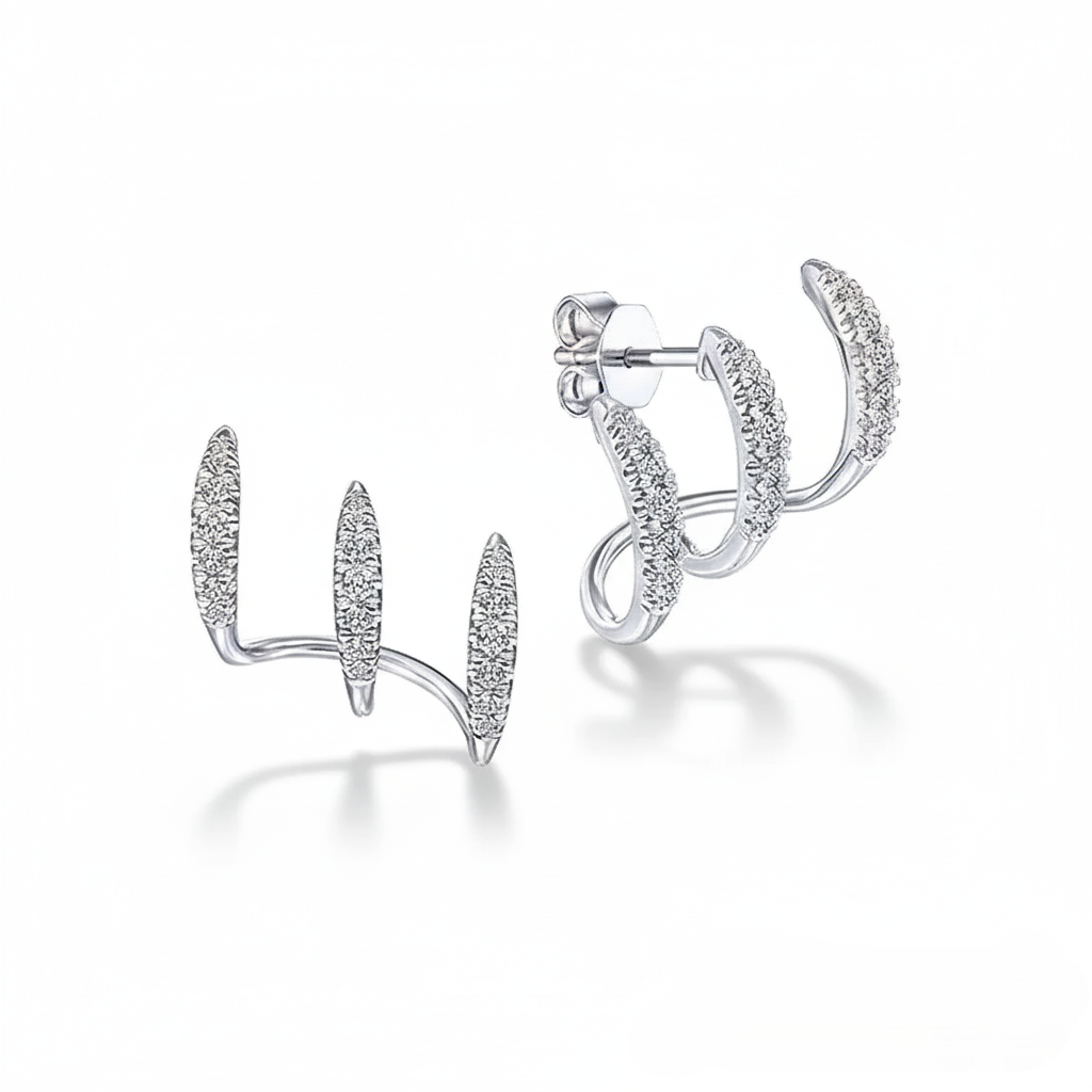 Silver stud earrings with an intricate design on a white background