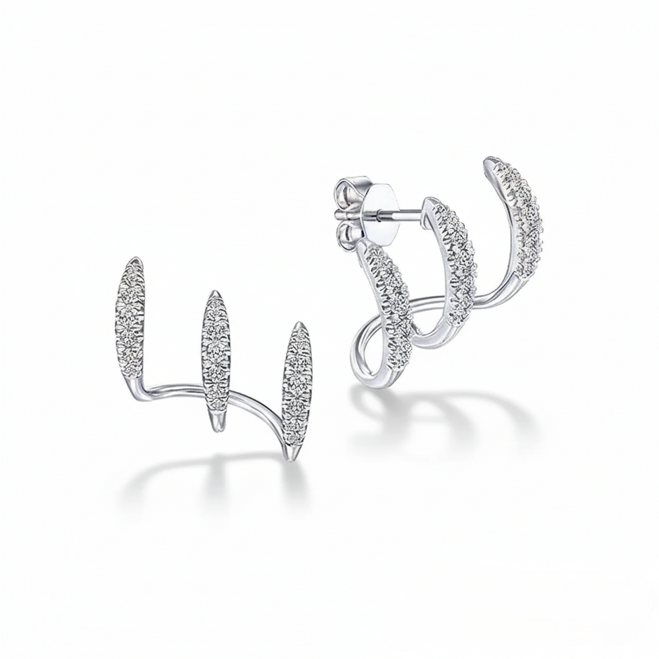 Silver stud earrings with an intricate design on a white background