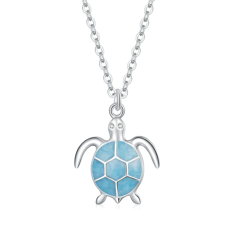 Silver turtle pendant with a blue shell on a white background