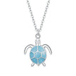 Silver turtle pendant with a blue shell on a white background