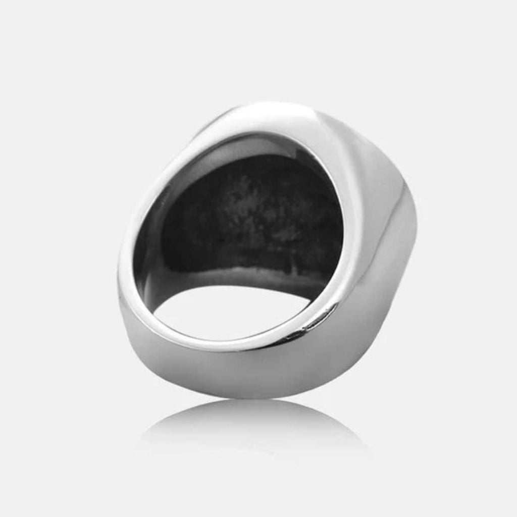Silver ring on a reflective white surface