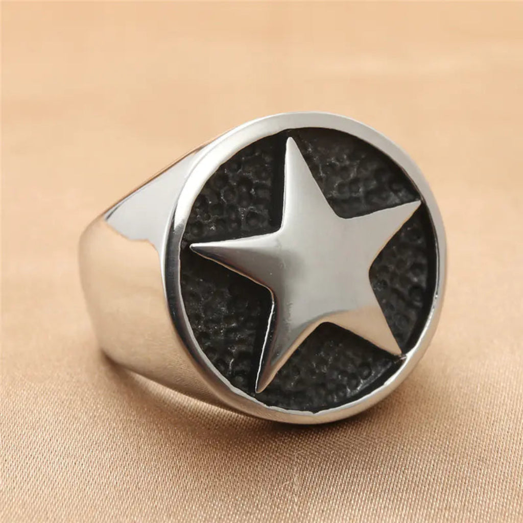 Titanium Signet Ring with Star Engraving on a beige background