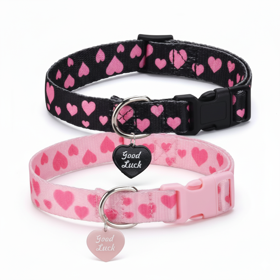 Two dog collars with a heart pattern, one black and one pink, on a white background.