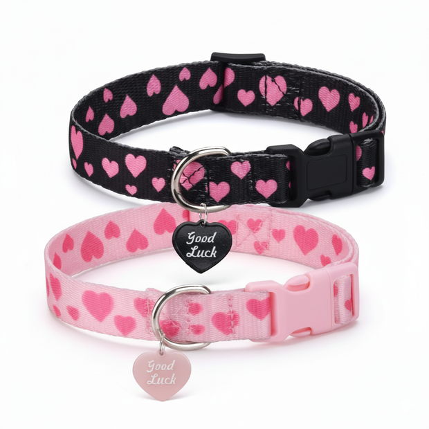 Two dog collars with a heart pattern, one black and one pink, on a white background.